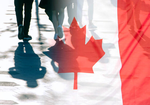 The National Flag of Canada and shadows of people, concept picture